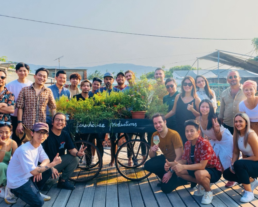 The Future Green community on a farm day, gathered around a flower cart in the sunshine